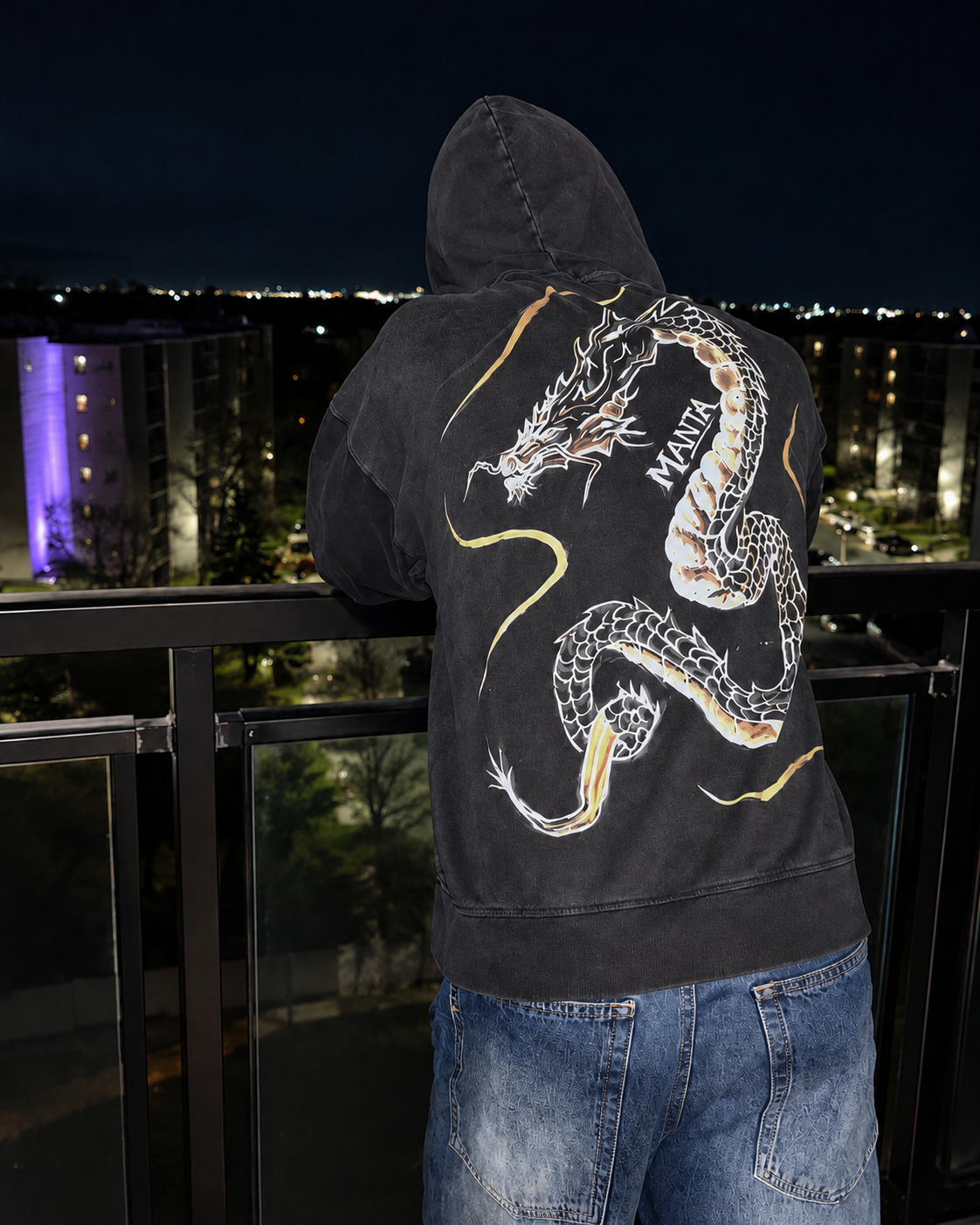 Black Manta bleach art dragon hoodie on a balcony at night